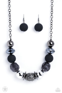 Sophisticated beads in shades of gunmetal and black with reflective faceted edges and varying glazed finishes are offset by two shiny silver beads. An oblong bead studded with gunmetal rhinestones adds a dramatic accent. Features an adjustable clasp closure.  Sold as one individual necklace. Includes one pair of matching earrings.