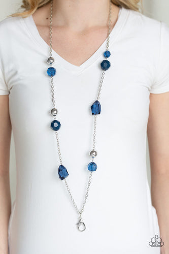 A collection of faceted blue gems, opaque blue beads, and polished silver beads trickle down a shimmery silver chain for a glamorous look. A lobster clasp hangs from the bottom of the design to allow a name badge or other item to be attached. Features an adjustable clasp closure.  Sold as one individual lanyard. Includes one pair of matching earrings.