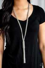 Load image into Gallery viewer, Shimmery strands of silver popcorn chain dramatically fall down the chest. An additional chain wraps around the cascading strands, creating a bold central pendant with shimmering tassels.  Sold as one individual necklace. Includes one pair of matching earrings.
