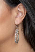 Load image into Gallery viewer, Shimmery silver circles hanging from a silver fish hook earring.
