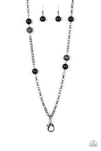 Load image into Gallery viewer, Shiny black beads and ornate gunmetal beads trickle along a bold gunmetal chain, creating a colorfully industrial look across the chest. A lobster clasp hangs from the bottom of the design to allow a name badge or other item to be attached. Features an adjustable clasp closure.  Sold as one individual lanyard. Includes one pair of matching earrings.
