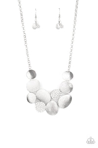 Featuring imperfect oval shapes, a series of delicately scratched and white rhinestone encrusted frames connect into a clustered pendant below the collar for a refined flair. Features an adjustable clasp closure. Includes one pair of matching earrings.