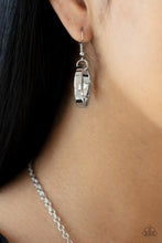 Load image into Gallery viewer, Thick silver ring hanging from a silver fish hook earring.
