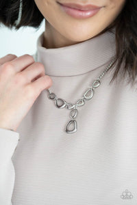 Irregular shaped silver rings connect to a sliver chain as they make their way across the collar. Two rings dangle from the center for a stylish avant-garde fashion. Features an adjustable clasp closure. Includes one pair of matching earrings.