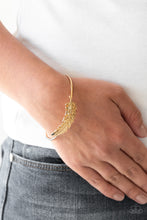 Load image into Gallery viewer, Featuring life-like detail, a shimmery gold feather folds along a dainty silver cuff for a seasonal look.  Sold as one individual bracelet.
