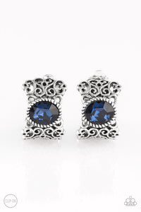 Brushed in an antiqued shimmer, vine-like filigree climbs into a glistening silver hoop. A glittery blue rhinestone is pressed into the top of the frame for a regal finish. Earring attaches to a standard clip-on fitting.  Sold as one pair of clip-on earrings.