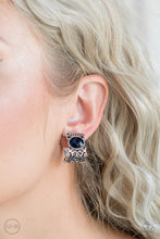 Load image into Gallery viewer, Brushed in an antiqued shimmer, vine-like filigree climbs into a glistening silver hoop. A glittery blue rhinestone is pressed into the top of the frame for a regal finish. Earring attaches to a standard clip-on fitting.  Sold as one pair of clip-on earrings.
