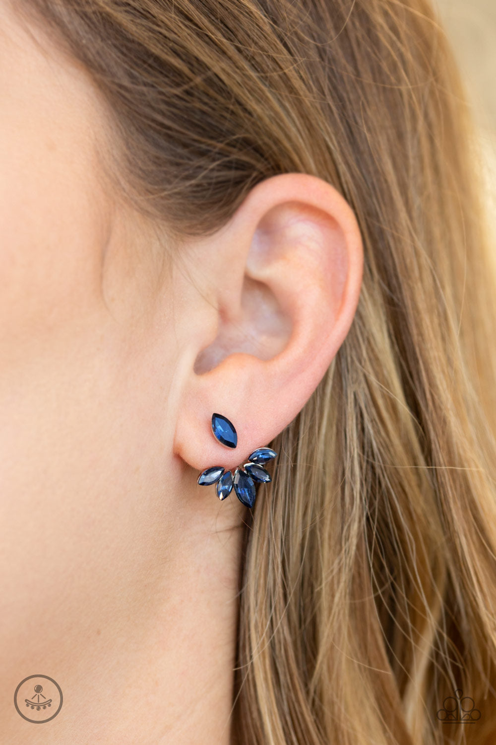 A solitaire blue marquise cut rhinestone attaches to a double-sided post, designed to fasten behind the ear. Encrusted in matching blue rhinestones, a double-sided post peeks out beneath the ear, creating a glittery fringe. Earring attaches to a standard post fitting.  Sold as one pair of post earrings.