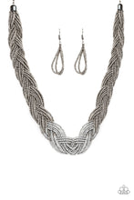 Load image into Gallery viewer, Strands of gunmetal seed beads create an indigenous braid below the collar. The gunmetal seed beads gradually morph into metallic silver beads at the center for a chic contrasting look. Features an adjustable clasp closure. Sold as one individual necklace. Includes one pair of matching earrings.
