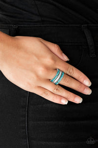 Featuring refined marquise cuts, glittery blue rhinestones flare from a center of glassy white rhinestones, creating a regal band across the finger. Features a stretchy band for a flexible fit.  Sold as one individual ring.