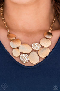 A collection of asymmetrical oval discs connect into a clustered pendant below the collar for a refined flair. Etched linear textures or white rhinestones adorn each disc, offering a gorgeous collision of texture, sheen, and sparkle. Features an adjustable clasp closure. Includes one pair of matching earrings