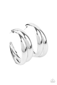 Two thick silver bars delicately overlap into a boldly oversized hoop. Earring attaches to a standard post fitting. Hoop measures approximately 2" in diameter.  Sold as one pair of hoop earrings.