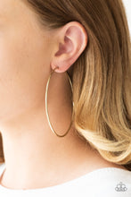 Load image into Gallery viewer, A skinny ribbon of brass curls into a bold hoop for a dramatic look. Earring attaches to a standard post fitting. Hoop measures 3” in diameter.  Sold as one pair of hoop earrings.
