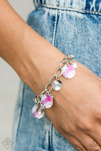 Featuring a galactic tie dye print, a collection of colorful and dainty silver discs swings from a bulky silver chain around the wrist for a trendy finish. Features an adjustable clasp closure.