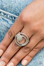 Load image into Gallery viewer, A solid silver disc and airy silver hoops eclipse across the finger, delicately coalescing into an edgy offset frame. Features a stretchy band for a flexible fit.
