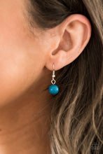 Load image into Gallery viewer, Blue bead hanging from a silver fish hook earring.
