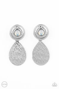 A hammered silver teardrop dangles from the bottom of an ornate silver disc that is dotted with a dreamy opal beaded center. Earring attaches to a standard clip-on fitting. Sold as one pair of clip-on earrings.