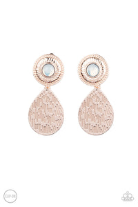 A hammered rose gold teardrop dangles from the bottom of an ornate rose gold disc that is dotted with a dreamy opal beaded center. Earring attaches to a standard clip-on fitting.  Sold as one pair of clip-on earrings.