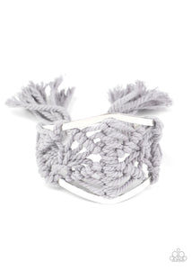 Ash cording decoratively knots and weaves around an airy silver cuff for a macramé inspired look. Knotted around the ends, Ash tassels flair out from the bottoms of the cuff for a wanderlust finish.  Sold as one individual bracelet.