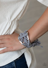 Load image into Gallery viewer, Ash cording decoratively knots and weaves around an airy silver cuff for a macramé inspired look. Knotted around the ends, Ash tassels flair out from the bottoms of the cuff for a wanderlust finish.  Sold as one individual bracelet.
