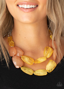 Varying in shape and size, opaque yellow and brown crystal-like beads delicately link into two colorfully icy layers below the collar for a stunning statement-making finish. Features an adjustable clasp closure.  Sold as one individual necklace. Includes one pair of matching earrings.