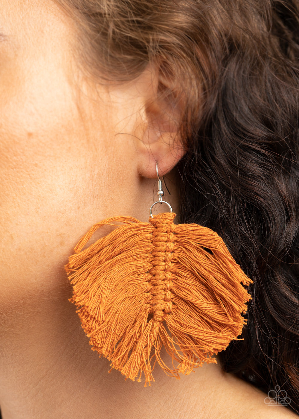 Rustic brown threaded tassels knot into a leaf-shaped frame, creating a colorful macramé inspired fringe. Earring attaches to a standard fishhook fitting.  Sold as one pair of earrings.