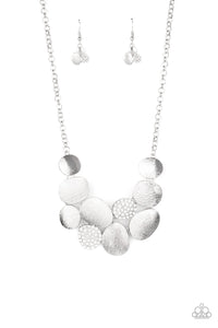 Featuring imperfect oval shapes, a series of delicately scratched and white rhinestone encrusted frames connect into a clustered pendant below the collar for a refined flair. Features an adjustable clasp closure.  Includes one pair of matching earrings.