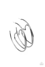 Load image into Gallery viewer, Glistening gunmetal wire delicately bends into an airy heart frame inside a classic gunmetal hoop, creating a flirtatious display. Earring attaches to a standard post fitting. Hoop measures approximately 2&quot; in diameter.  Sold as one pair of hoop earrings.

