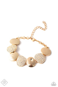 A collection of rounded golden discs wraps around the wrist in a blinding finish. Alternating between rhinestone-encrusted surfaces and strategically textured finishes, the pieces combine to create an elegant statement piece. Features an adjustable clasp closure.