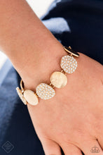 Load image into Gallery viewer, A collection of rounded golden discs wraps around the wrist in a blinding finish. Alternating between rhinestone-encrusted surfaces and strategically textured finishes, the pieces combine to create an elegant statement piece. Features an adjustable clasp closure.
