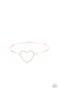 A dainty rose gold heart frame attaches to a dainty rose gold bangle-like cuff, creating a flirty centerpiece around the wrist. Features a toggle closure.  Sold as one individual bracelet.