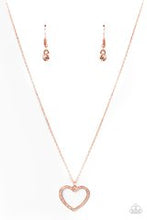 Load image into Gallery viewer, Encrusted in sparkly white rhinestones, an airy copper heart frame swings from a dainty copper chain below the collar for a romantic look. Features an adjustable clasp closure. Sold as one individual necklace. Includes one pair of matching earrings.
