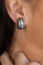 Load image into Gallery viewer, Studded in rows of linear texture, a rounded silver frame adorns the ear for a rustic look. Earring attaches to a standard clip-on fitting.  Sold as one pair of clip-on earrings.
