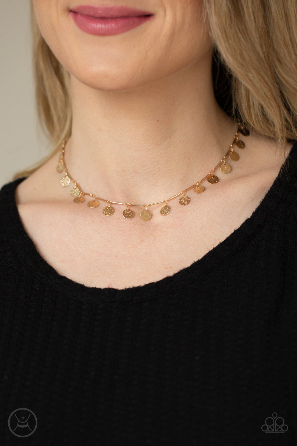 Hammered gold discs swing from interconnected gold bars around the neck, creating a shimmery fringe. Features an adjustable clasp closure.  Sold as one individual choker necklace. Includes one pair of matching earrings.