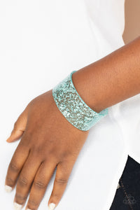 Dainty silvery shavings are encased in a thick blue acrylic cuff, creating an icy incandescence around the wrist.  Sold as one individual bracelet.