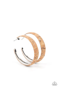 Silvery veins accent the front of a cork lined silver hoop, creating a refined display. Hoop measures approximately 2" in diameter. Earring attaches to a standard post fitting.  Sold as one pair of hoop earrings.