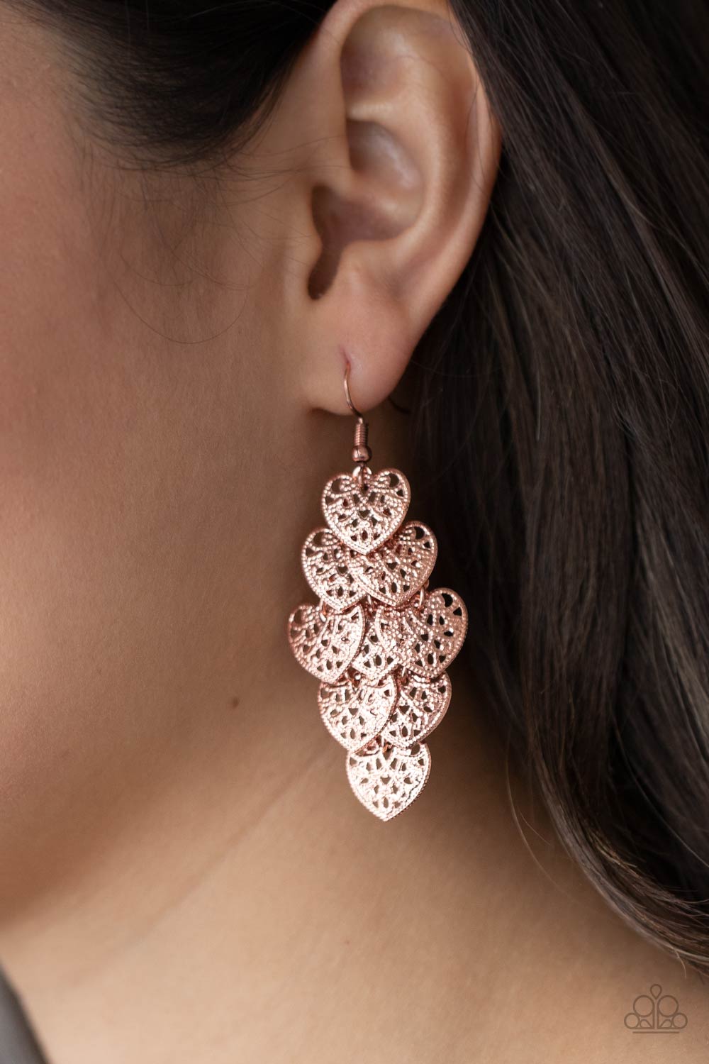 Featuring studded filigree filled centers, shiny copper heart frames cascade from the ear as they link into a flawless overlapping lure. Earring attaches to a standard fishhook fitting.  Sold as one pair of earrings.