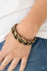 Featuring plain and textured finishes, chunky brass links interconnect into an edgy bangle-like cuff. Features a hinged closure.  Sold as one individual bracelet.