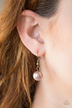 Load image into Gallery viewer, A brown pearl hanging from a  brass fish hook earring.
