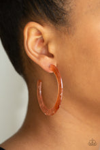Load image into Gallery viewer, Featuring flecks of shimmer, a coppery acrylic hoop curls around the ear for a retro-radiant look. Earring attaches to a standard post fitting. Hoop measures approximately 2 1/4&quot; in diameter. Sold as one pair of hoop earrings.
