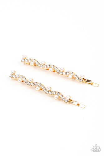 A wavy row of glittery white rhinestones is flanked between dainty white pearls along the front of a gold bobby pin for a refined fashion.  Sold as one pair of decorative bobby pins.