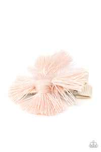 An earthy fringe of pale pink tassels are knotted together to form a boho-chic style over a white ribbon clip. Features a standard hair clip on the back.  Sold as one individual hair clip.