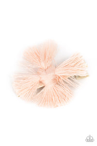 An earthy fringe of pale pink tassels are knotted together to form a boho-chic style over a white ribbon clip. Features a standard hair clip on the back.  Sold as one individual hair clip.