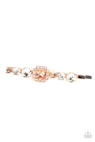 Featuring a brilliant radiant cut peach gem surrounded by a frame of dainty white rhinestones, a mismatched collection of white round and square peach rhinestones coalesce into a stunning display.  Sold as one individual bobby pin.