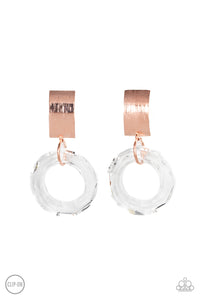 A faceted acrylic ring links to the bottom of a curved shiny copper plate, creating a modern lure. Earring attaches to a standard clip-on fitting.  Sold as one pair of clip-on earrings.