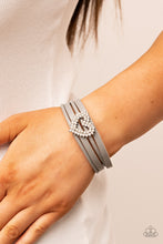 Load image into Gallery viewer, Featuring pronged silver fittings, two rows of glassy white rhinestones stack into a sparkly heart frame that is threaded along layers of Ultimate Gray leather strands around the wrist. Features a magnetic closure.  Sold as one individual bracelet.
