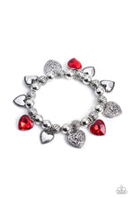 Load image into Gallery viewer, Decorative silver filigree, silver-studded, and red gem heart charms swing from a collection of shiny silver beads, and silver beads with a dot motif. Threaded along an elastic stretchy band, the charming bracelet creates a timeless romantic centerpiece around the wrist.  Sold as one individual bracelet.
