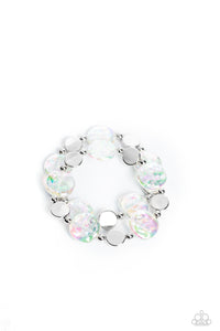 Shiny silver discs, studs, and asymmetrical clear discs featuring an iridescent shimmer coalesce around the wrist on elastic stretchy bands for an attention-grabbing shimmer. Due to its prismatic palette, color may vary.  Sold as one set of two bracelets.