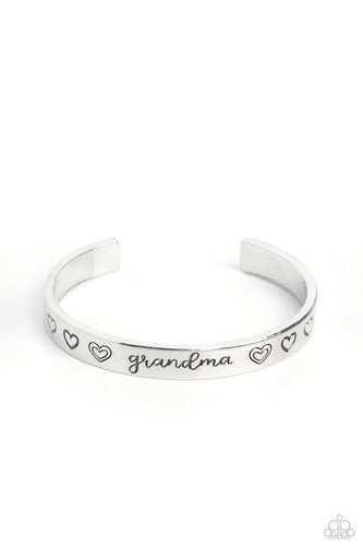 Brushed in a polished sheen, a skinny silver bar curls around the wrist, creating a rustic cuff. Featuring a heart motif, the skinny cuff is engraved with the word “grandma” with various styles of hearts framing the word for an inspiring, heartfelt finish.  Sold as one individual bracelet.