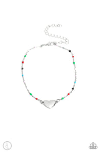 A dainty strand of multicolored beaded silver chain wraps around the ankle for a dainty pop of color. An imperfect silver heart rests in the center of the beaded strand for a romantic finish. Features an adjustable clasp closure.  Sold as one individual anklet.